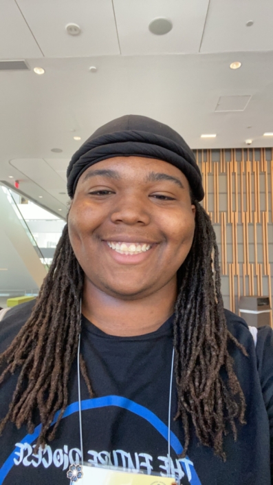 Image Description: A photo of Ameir Reed. He's wearing a t-shirt and smiling broadly toward the camera.